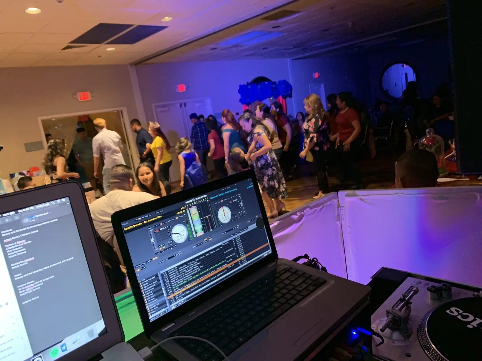 View from the DJ booth toward guests on the dance floor