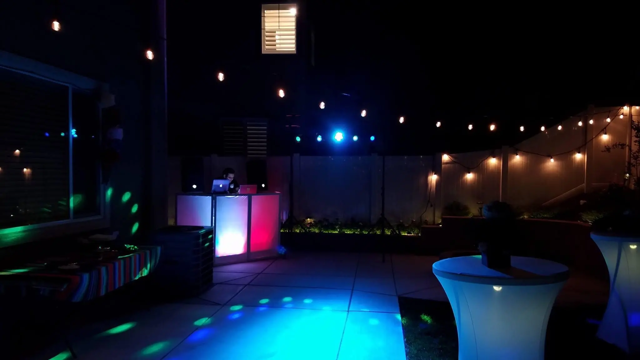 Colorful DJ booth lighting at an outdoor Southern California event