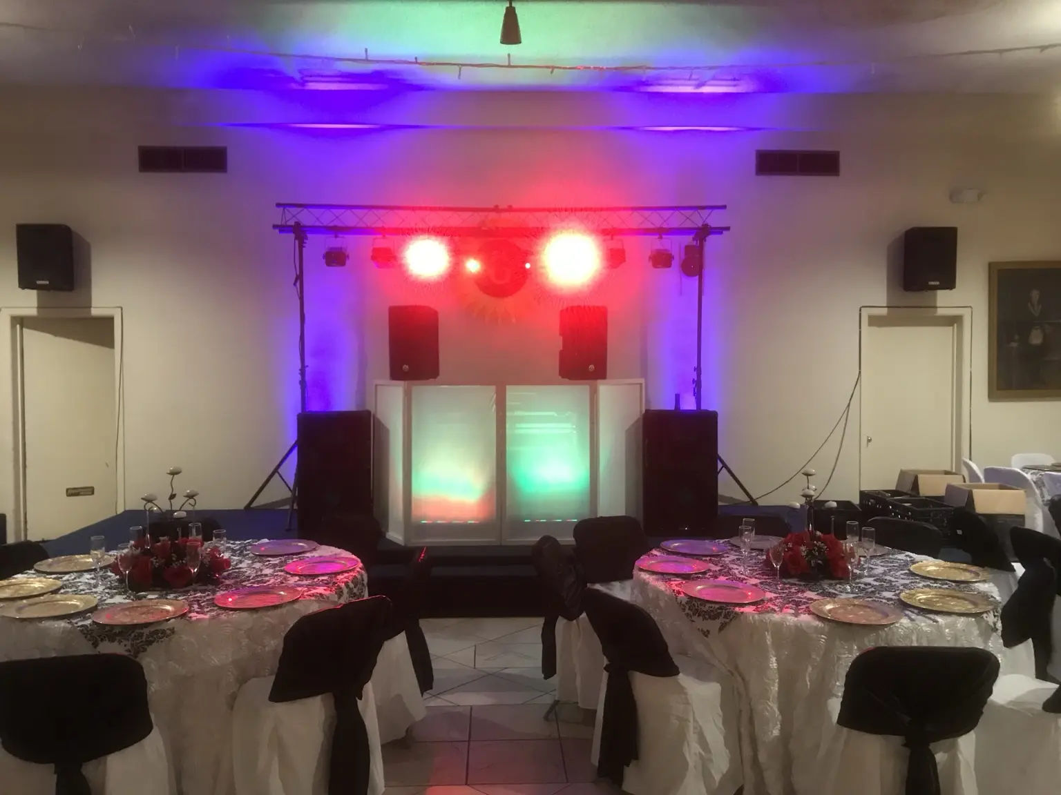 DJ lighting setup between decorated reception tables