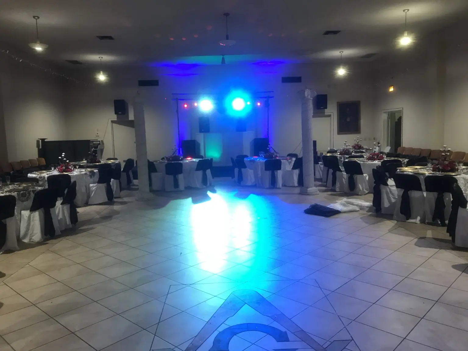 Wide view of a prepared reception venue and dance floor